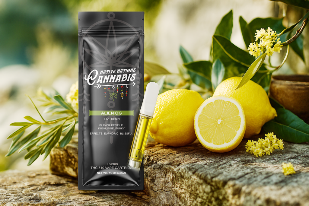 Alien OG vape cartridge and branded packaging from Native Nations Cannabis displayed next to fresh lemons and lemon blossoms on a rustic wooden surface.
