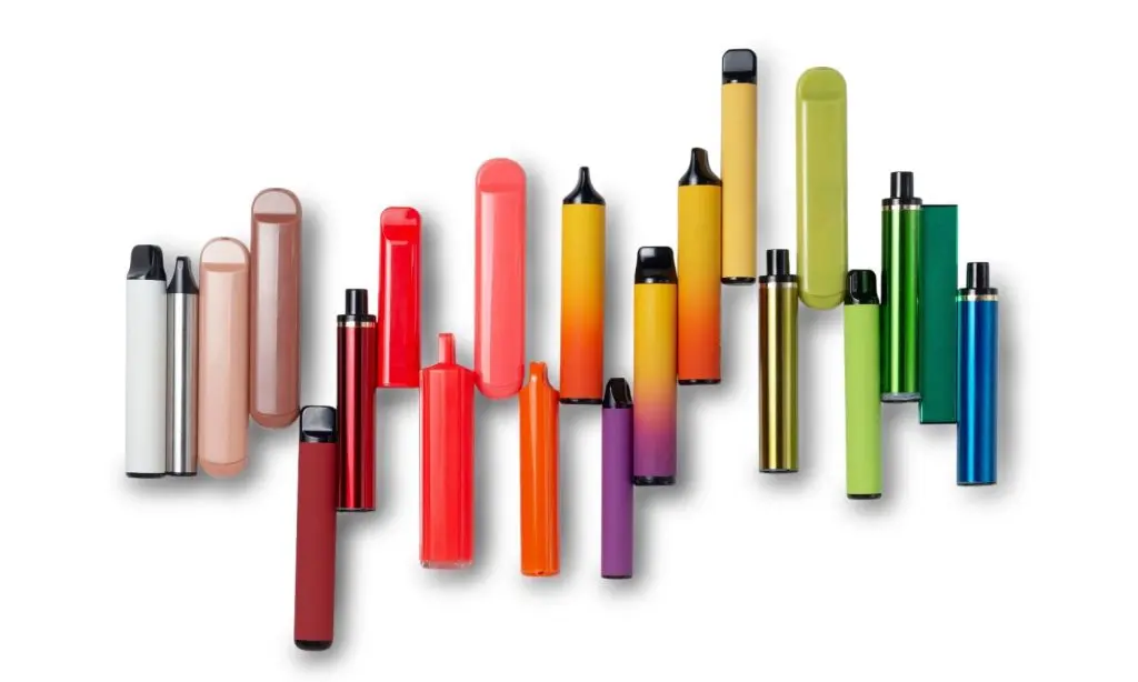 A variety of colorful disposable vape pens arranged in a row, each with different shapes and vibrant colors on a white background.