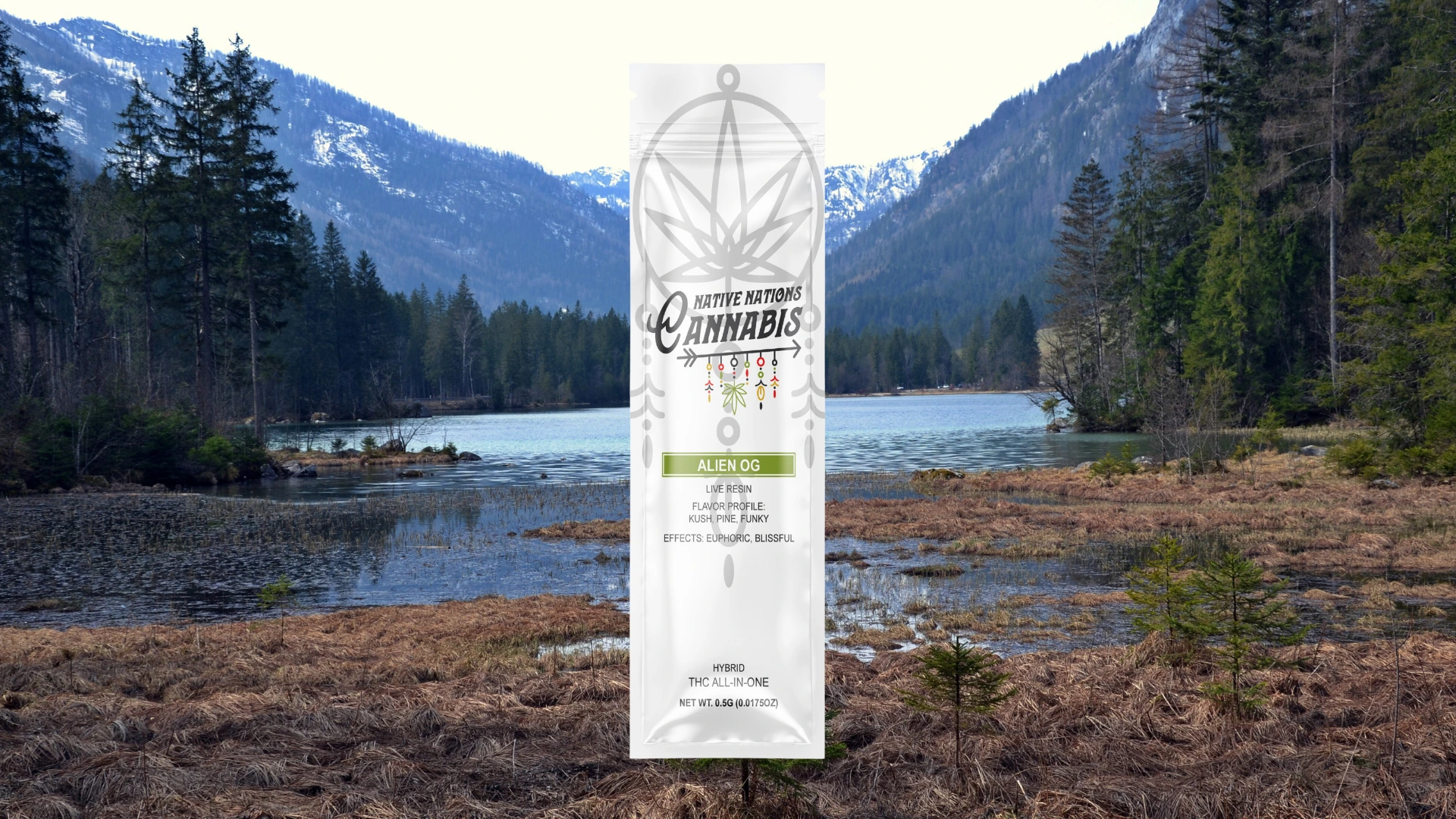 Cannabis vape cartridge packaging labeled "Alien OG" by Native Nations Cannabis set against a serene mountain lake backdrop.
